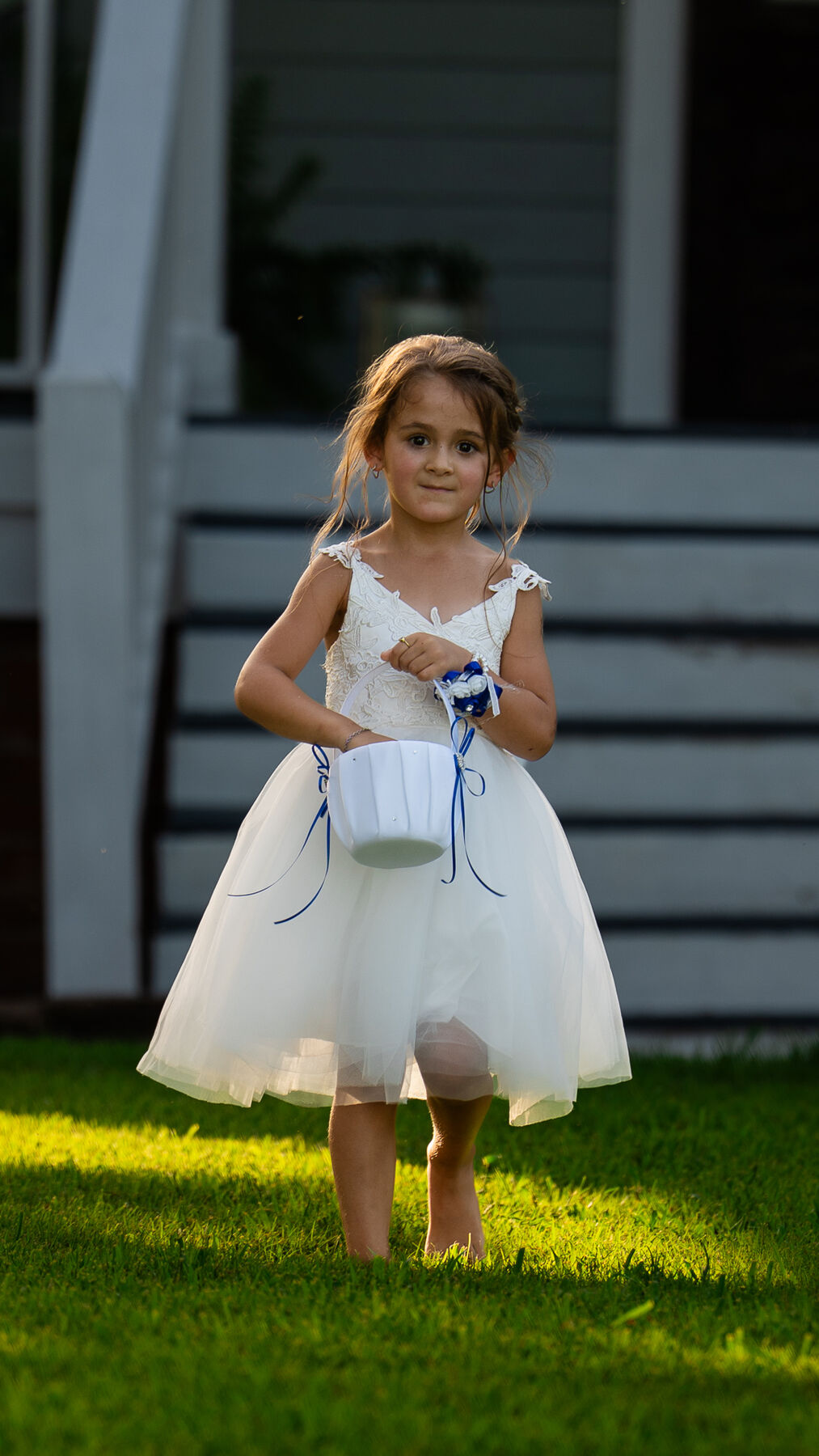 Flower girl walking down the aisle in golden evening light