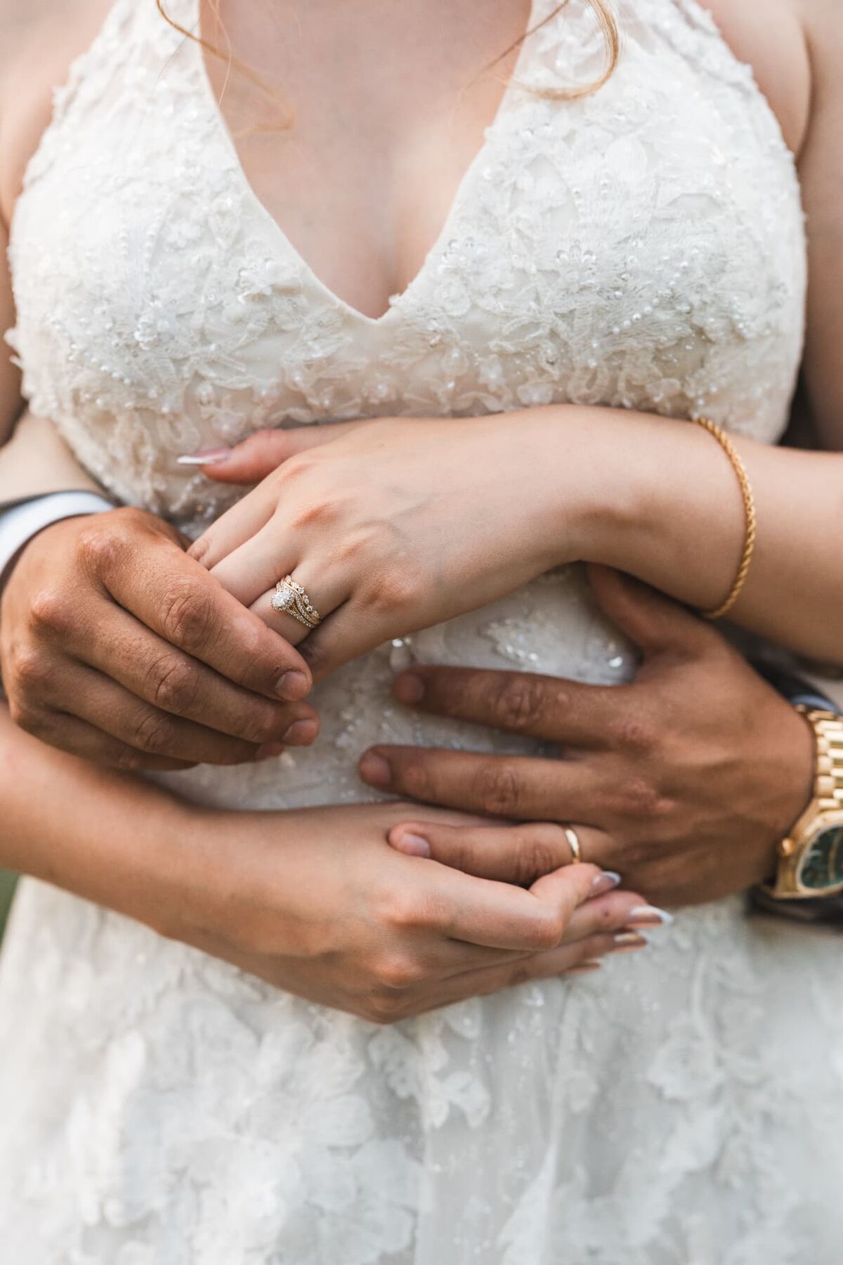 Close-up of a bride and groom's hands and wedding rings